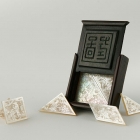 紅木盒裝螺鈿刻花七巧板<br/ ><b>Tangram puzzle <i>(qiqiao ban)</i></b><br />Mother-of-pearl pieces in hongmu box<br />Canton; Qing dynasty, 19th c.<br />2.1 x 2.1 x 0.6 in<br /><em>Yi Zhi Tang</em> Collection 71-005